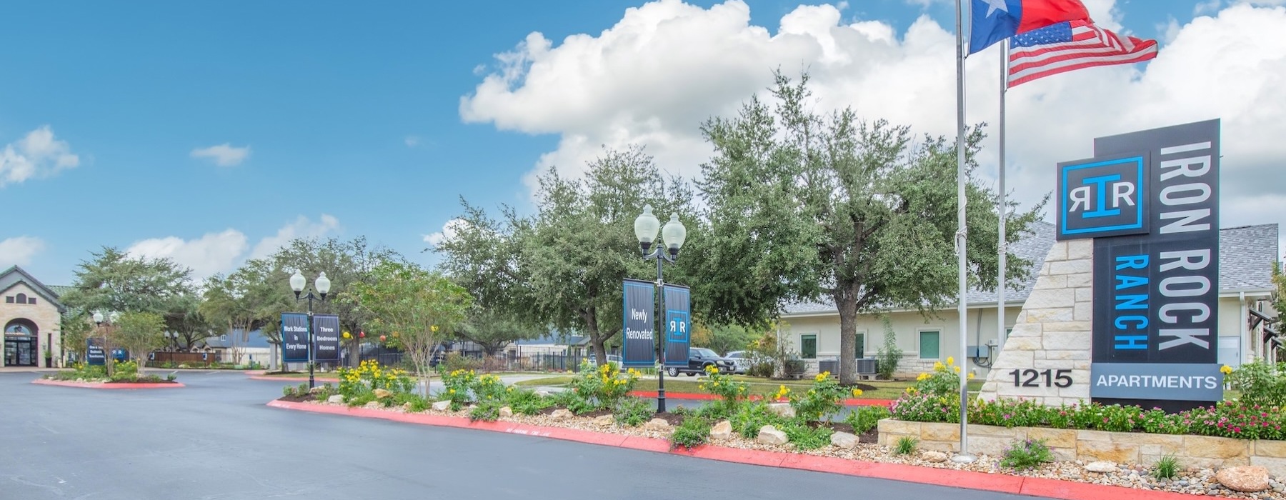 a road with flags and a sign
