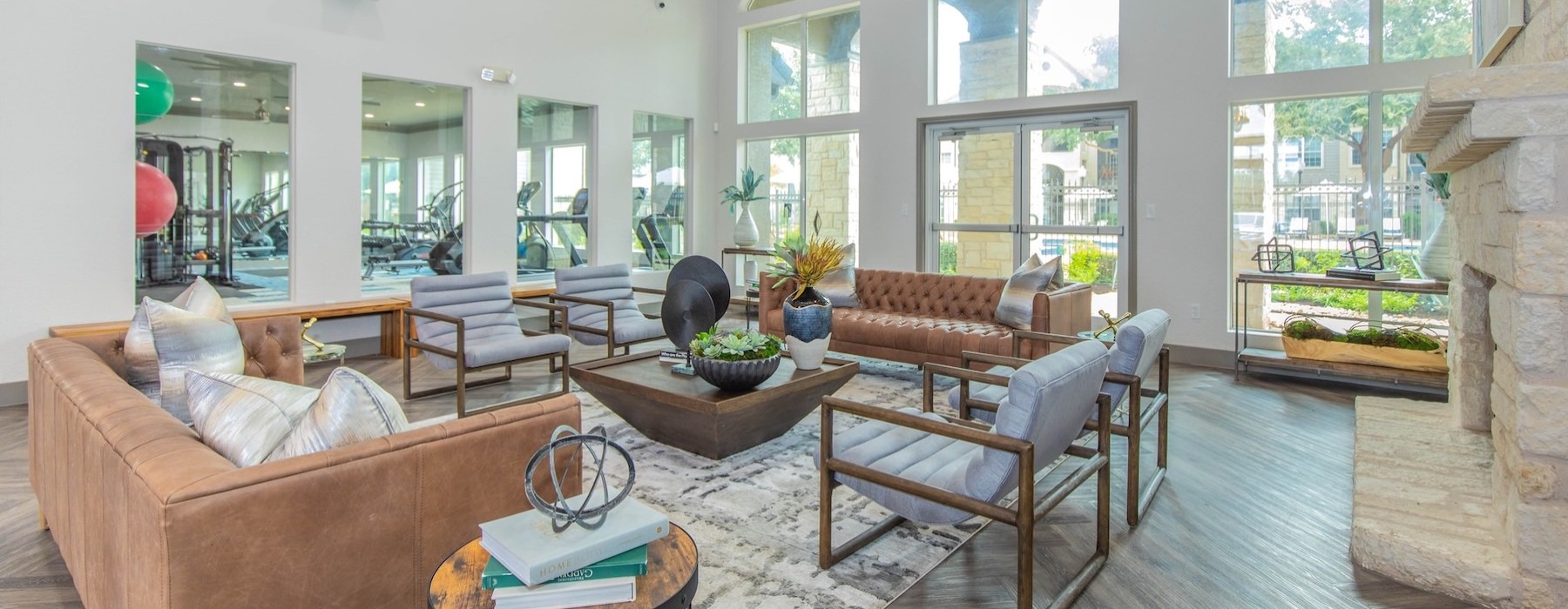 a clubroom with tables, chairs and couches