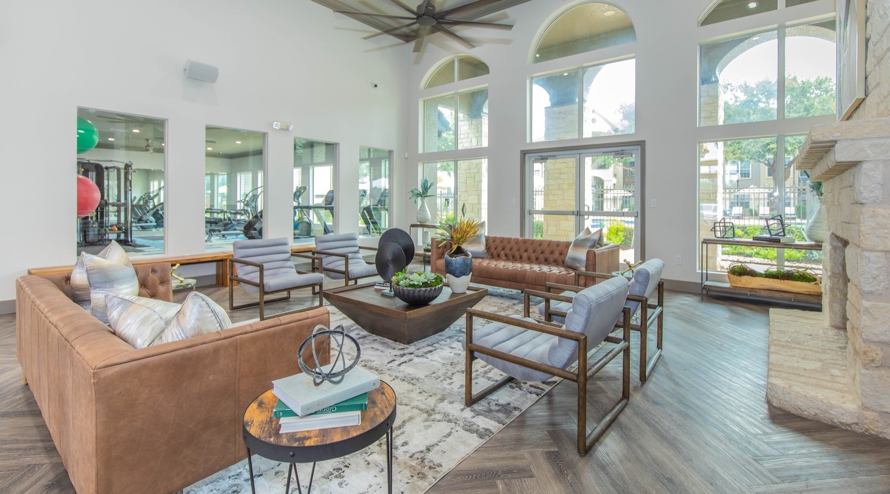 a clubroom with tables, chairs and couches