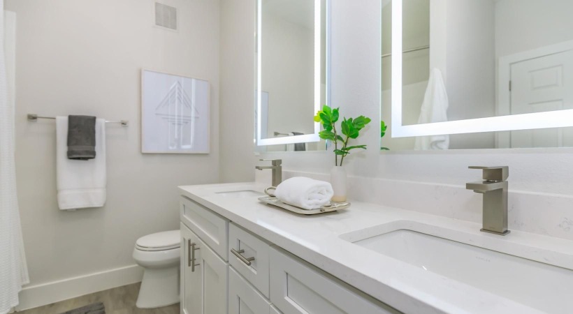 a bathroom with white cabinets