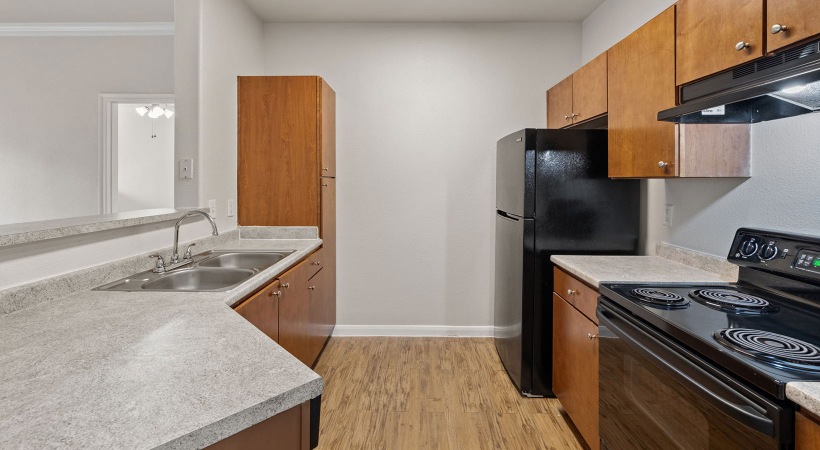 kitchen with wood cabinets and black appliances